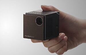The UO Smart Beam Projector Packs A Big Image In A Small Cube